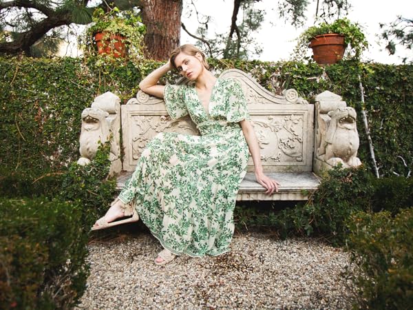 Model with a patterned dress sitting in a garden