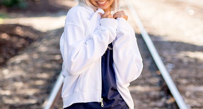 Female model wearing Brisco Brands zip up sweatshirt